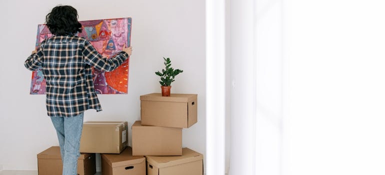 A person holding a painting 