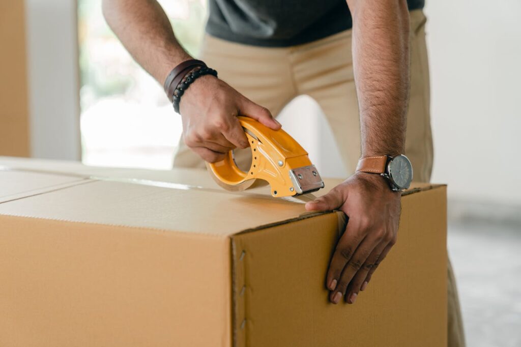 one of Affton movers taping a box