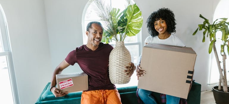 a couple holding items before moving with local movers in St. Louis 