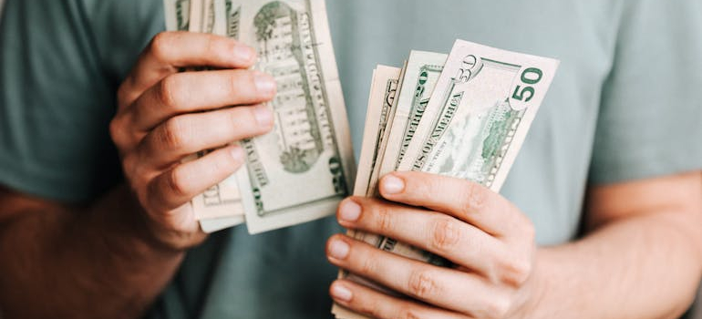 a person counting money before moving to St. Louis