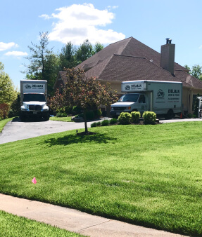 house and two moving trucks